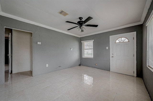 entryway with ornamental molding, ceiling fan, and light tile patterned floors