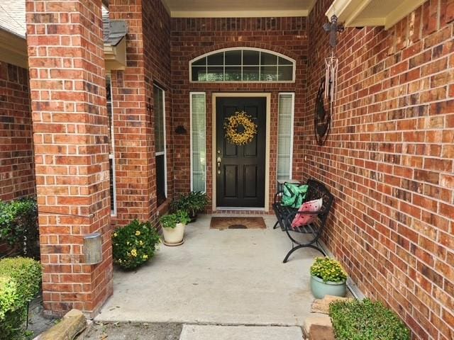 property entrance with brick siding