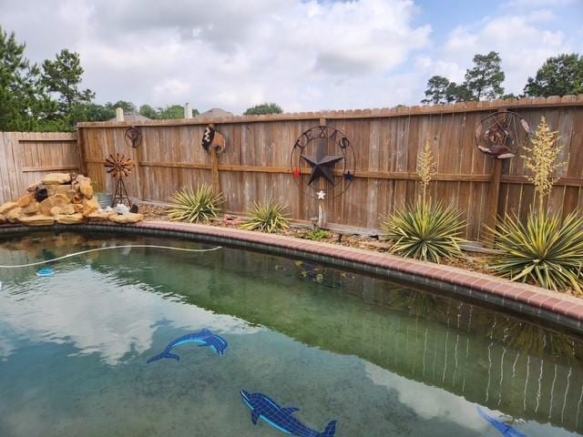 view of pool with fence