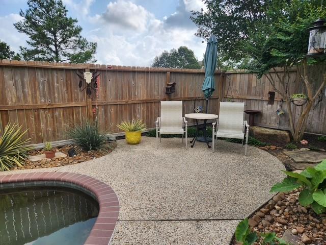 view of patio / terrace with fence and an outdoor pool