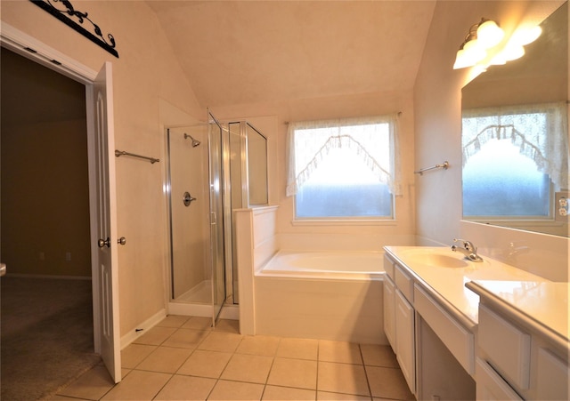 full bath with tile patterned flooring, vaulted ceiling, a shower stall, vanity, and a bath