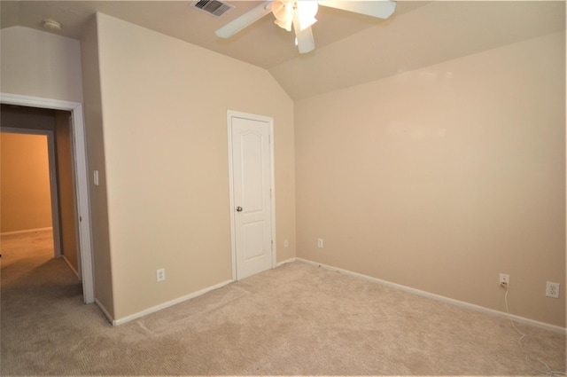 unfurnished bedroom with carpet, lofted ceiling, baseboards, and a ceiling fan