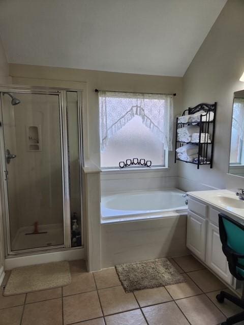 bathroom featuring plenty of natural light, tile patterned flooring, lofted ceiling, and a stall shower