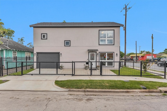 view of front facade featuring a garage, a fenced front yard, a gate, and concrete driveway