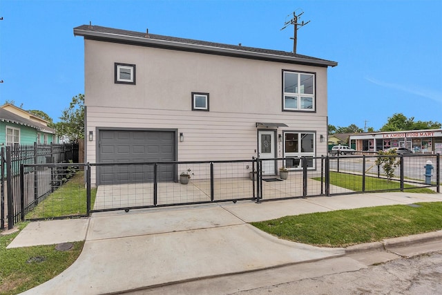 view of front facade with a gate, a garage, and concrete driveway
