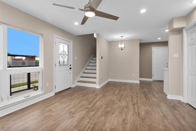 unfurnished living room featuring baseboards, light wood-style flooring, stairway, recessed lighting, and a ceiling fan