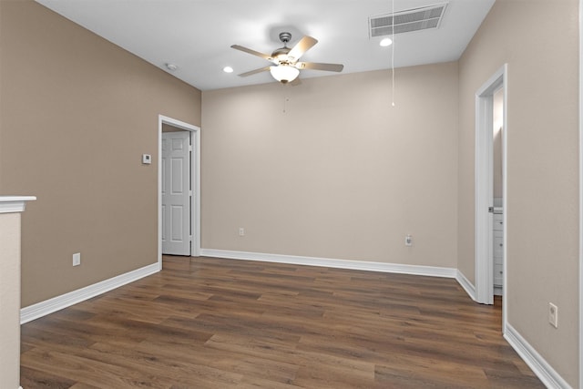spare room featuring ceiling fan, dark wood-type flooring, attic access, baseboards, and recessed lighting