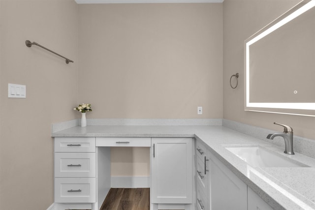 bathroom with vanity and wood finished floors