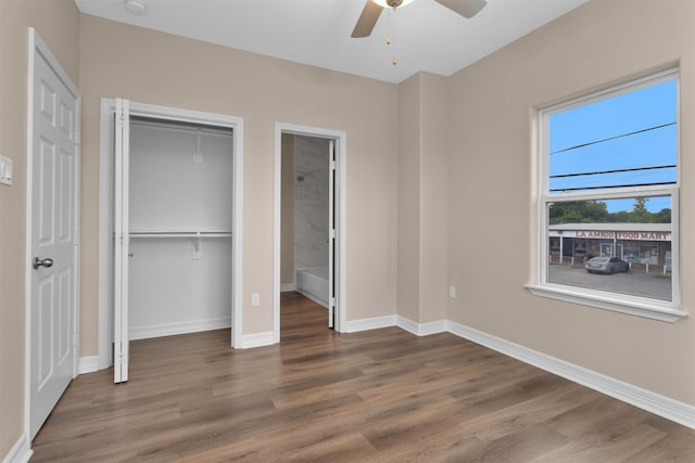unfurnished bedroom with wood finished floors and baseboards