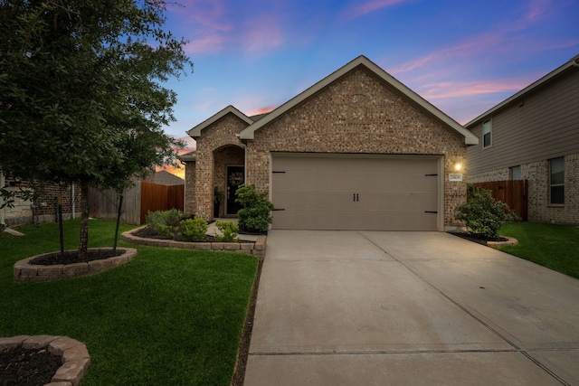 23808 Flora Rosso Way, New Caney, TX 77357 - view of front of property with brick siding, driveway, and a garage
