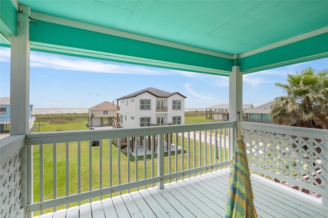 deck with a yard and a residential view