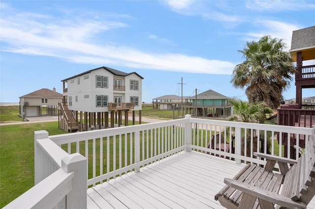wooden deck featuring a lawn, stairs, and a residential view