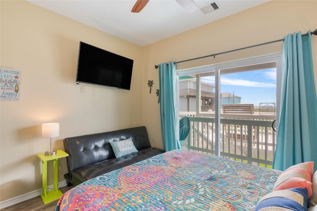 bedroom with access to exterior, baseboards, wood finished floors, and ceiling fan
