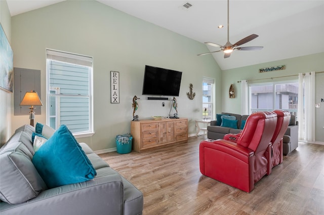 living room featuring ceiling fan, wood finished floors, baseboards, and high vaulted ceiling