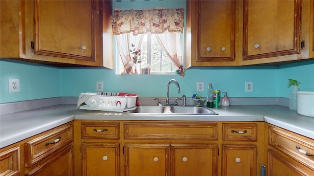 415 Briarcliff Dr, Houston, TX 77076 - kitchen with a sink, brown cabinetry, and light countertops