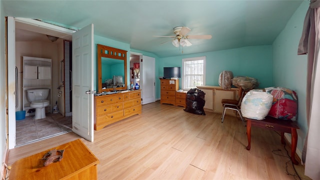 415 Briarcliff Dr, Houston, TX 77076 - bedroom with light wood-style flooring, ensuite bath, and a ceiling fan