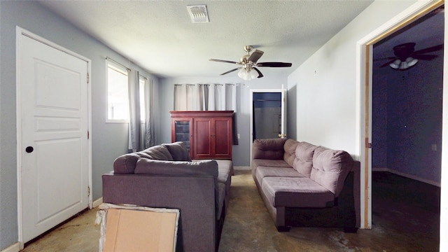 415 Briarcliff Dr, Houston, TX 77076 - living room featuring a ceiling fan, baseboards, and a textured ceiling
