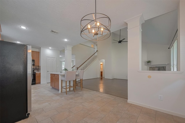 dining space with decorative columns, stairway, recessed lighting, a chandelier, and ceiling fan