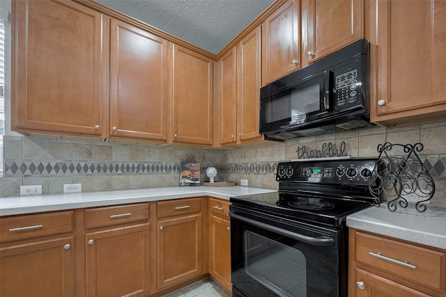 kitchen with black appliances, light countertops, backsplash, and a textured ceiling