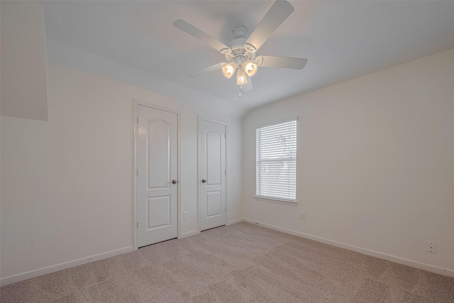 31214 Windcrest Park Ln, Spring, TX 77386 - unfurnished bedroom with light colored carpet, baseboards, and a ceiling fan