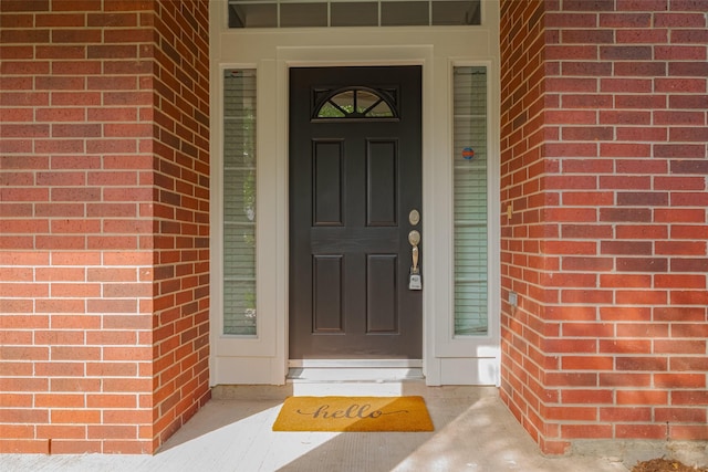 property entrance with brick siding