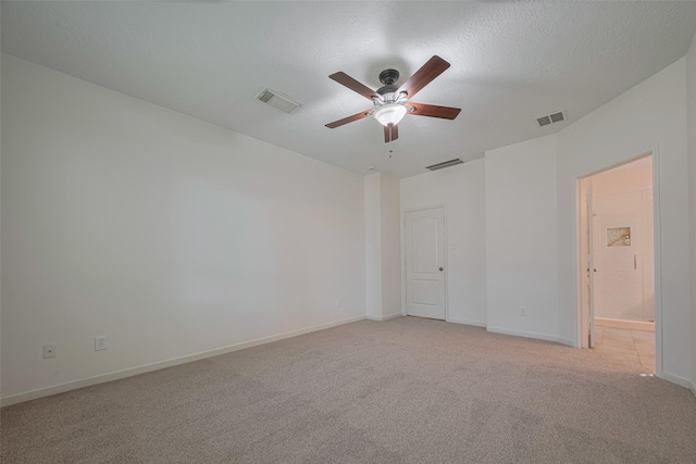 empty room with a ceiling fan, light carpet, and baseboards