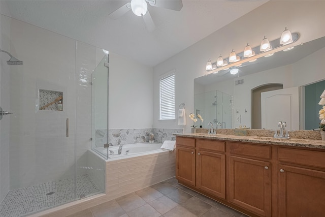 bathroom with a stall shower, a bath, tile patterned floors, ceiling fan, and double vanity