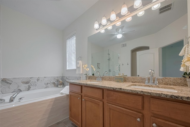 bathroom featuring a shower stall, a bath, double vanity, a ceiling fan, and tile patterned floors