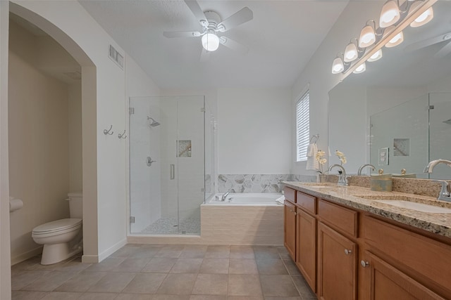 bathroom featuring a garden tub, a ceiling fan, tile patterned flooring, toilet, and a shower stall