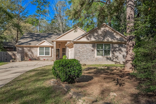 194 Velvet Leaf Pl, The Woodlands, TX 77380 - ranch-style house featuring brick siding, concrete driveway, a garage, and fence
