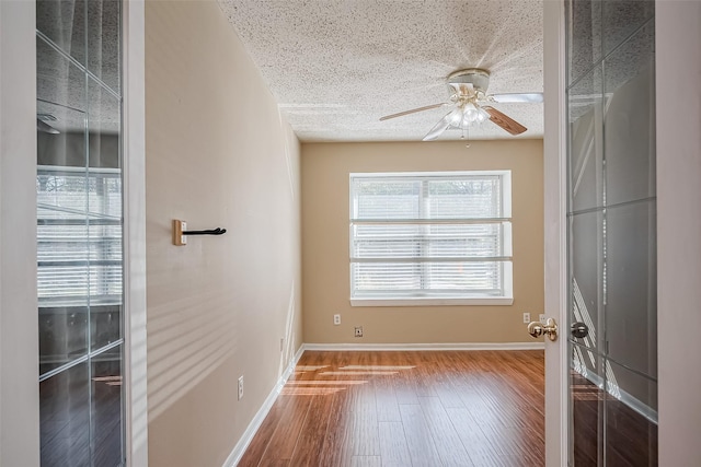 194 Velvet Leaf Pl, The Woodlands, TX 77380 - unfurnished room featuring ceiling fan, wood finished floors, a textured ceiling, and baseboards