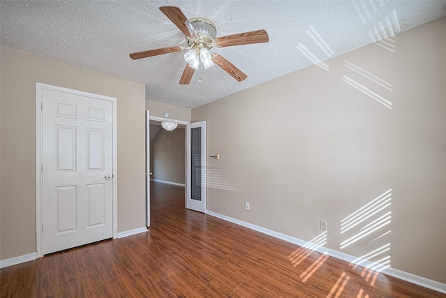 194 Velvet Leaf Pl, The Woodlands, TX 77380 - unfurnished bedroom with a textured ceiling, wood finished floors, and baseboards