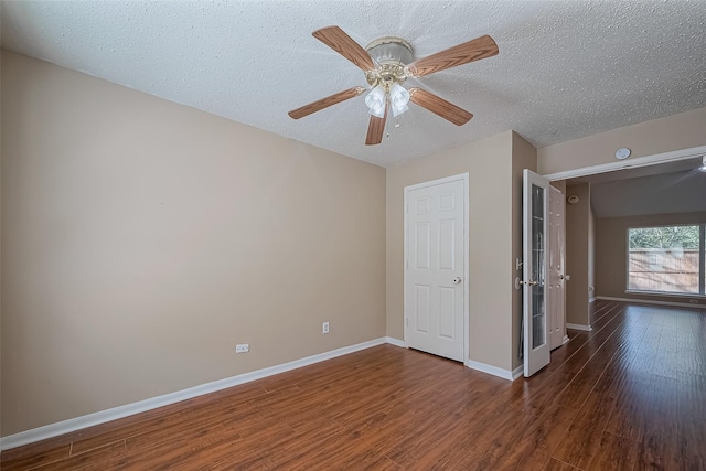194 Velvet Leaf Pl, The Woodlands, TX 77380 - unfurnished room with dark wood-style flooring, a textured ceiling, baseboards, and ceiling fan