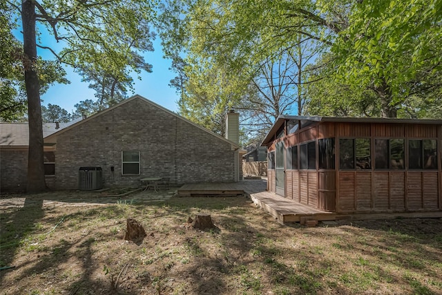 194 Velvet Leaf Pl, The Woodlands, TX 77380 - view of side of property featuring a chimney, brick siding, cooling unit, and a wooden deck