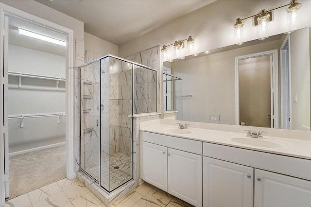 9438 Caddo Ridge Ln, Cypress, TX 77433 - full bath with marble look tiles, a marble finish shower, a walk in closet, and double vanity