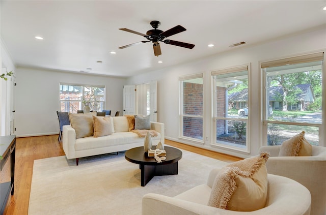 living area featuring light wood-style floors, recessed lighting, and a ceiling fan