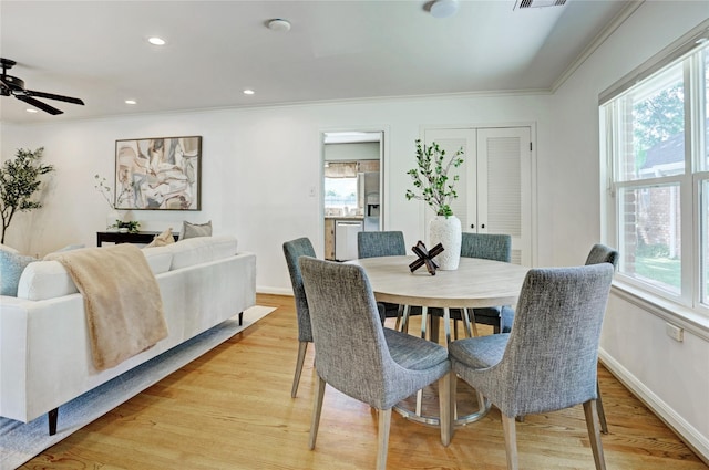 dining space with plenty of natural light, ornamental molding, light wood finished floors, ceiling fan, and recessed lighting