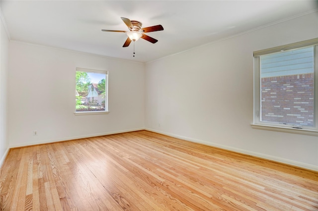 empty room featuring wood finished floors, baseboards, ceiling fan, and crown molding