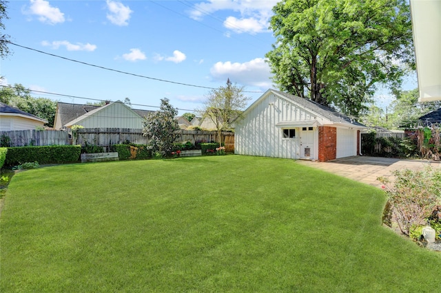 view of yard with a detached garage and an outbuilding
