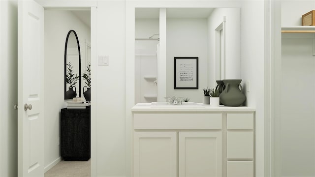 full bath with vanity and baseboards
