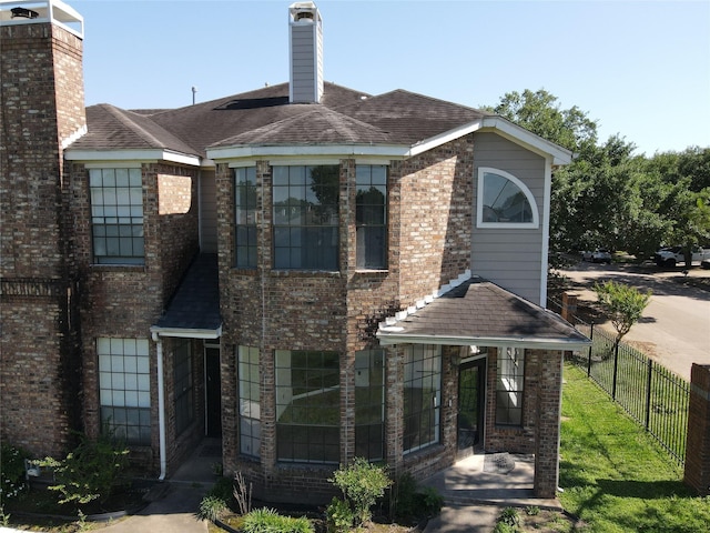 8888 Benning Dr Unit 313, Houston, TX 77031 - view of front of house featuring fence, roof with shingles, and brick siding