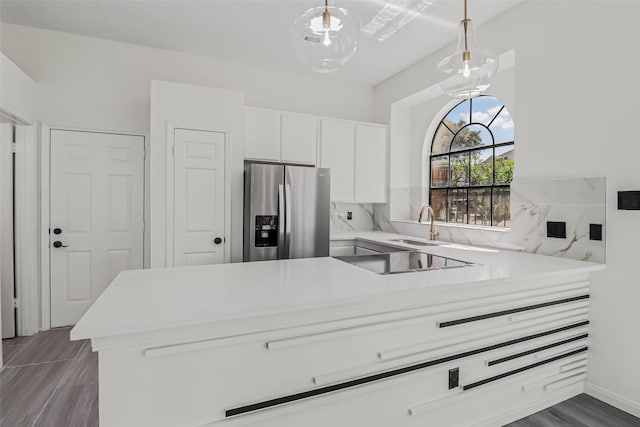 8888 Benning Dr Unit 313, Houston, TX 77031 - kitchen featuring stainless steel fridge, light countertops, white cabinets, decorative light fixtures, and a sink