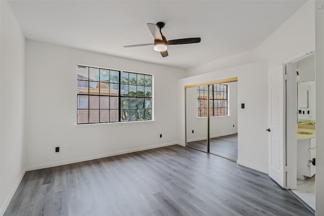 8888 Benning Dr Unit 313, Houston, TX 77031 - unfurnished bedroom with wood finished floors, ceiling fan, baseboards, and a closet