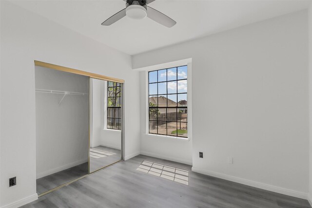 8888 Benning Dr Unit 313, Houston, TX 77031 - unfurnished bedroom featuring wood finished floors, a closet, baseboards, and ceiling fan
