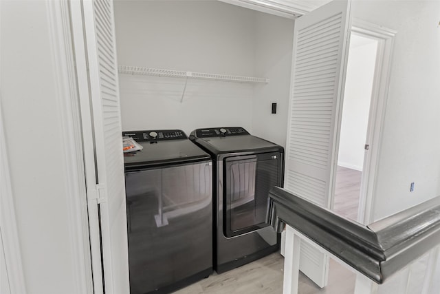 8888 Benning Dr Unit 313, Houston, TX 77031 - clothes washing area with washing machine and clothes dryer and light wood-style floors