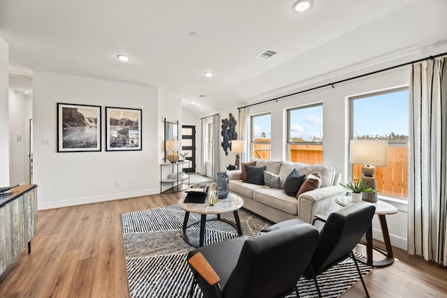 living area with light wood-style floors, recessed lighting, and baseboards