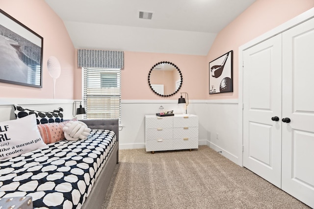 bedroom with lofted ceiling, carpet, a closet, and baseboards