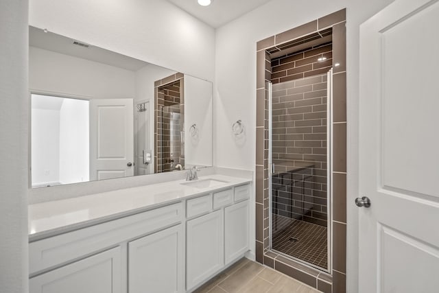 full bath with a stall shower and vanity
