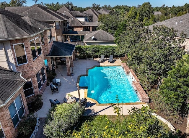 view of pool with a patio and a residential view