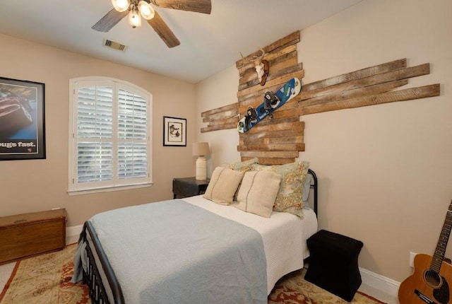 bedroom featuring baseboards and ceiling fan